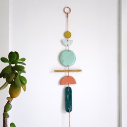 Decorative wall hanging with various shapes and colors including circles, rectangles, and a pendant in mint, coral, ocean, and kobalt colors.