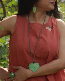  Green leaf-shaped papier-mache pendant, natural botanical design, handmade artisan jewelry accessory.