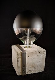 Raw concrete design table lamp with industrial cement and steel construction. Rectangular shape with a round glass dome light fixture.