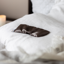 Organic herbal care pillow with lavender scent for sleep and relaxation. Soft, plush fabric in a soothing gray color.
