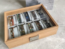 Wooden bracelet display case with 10 cushions for organizing and showcasing bracelets.