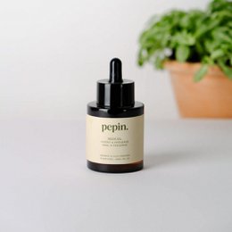 Natural insecticide for plants, made from neem oil, in a clear glass bottle with a spray nozzle.