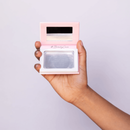 Transparent soap booster with a pink and white compact design.