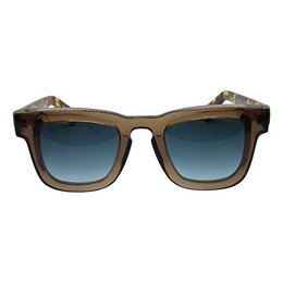 Rectangular sunglasses with a tortoiseshell frame and animal print accents. The lenses have a gradient blue tint.