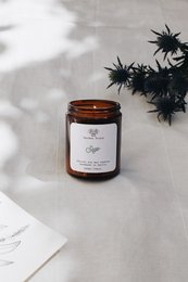 Sage-scented candle in a glass jar with a black lid. The candle has a warm, earthy aroma and is available in multiple sizes.