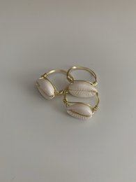 Delicate gold-toned rings featuring natural shell accents, available in stacking styles. Crafted with a minimalist aesthetic, these rings can be worn alone or layered for a chic, bohemian look.