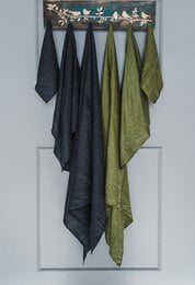 Soft, absorbent linen bath towels in a variety of neutral and muted colors including natural linen, off-white, white, pale dogwood, rust, forest green, dusk blue, lavender, and charcoal gray. Ideal for a relaxing, spa-like bathroom experience.