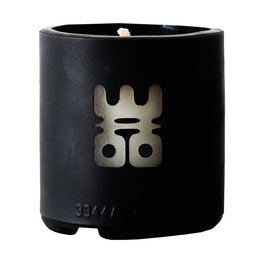 A round, tall black candle with a minimalist design featuring a metallic logo.