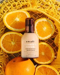 Vitamin C facial serum in 30ml and 50ml sizes, with a pink and rose gold bottle design, containing a nourishing and brightening formula.