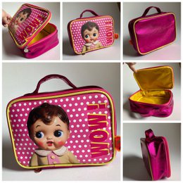  Retro doll toiletry bag, pink polka dot pattern, vintage doll face design, metallic gold and magenta interior, rectangular shape with handles.