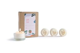 White heart-shaped tealight candles in a decorative box with floral patterns.