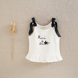  "White baby girl's tank top with 'Mini star' text and ruffle details. Suitable for ages 12-36 months."