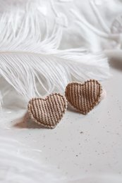  Beige heart-shaped hair clips with a textured, woven design. Suitable for kids' hairstyles.
