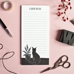 A notepad with a silhouette of a cat and a potted plant, perfect for jotting down notes and to-do lists.
