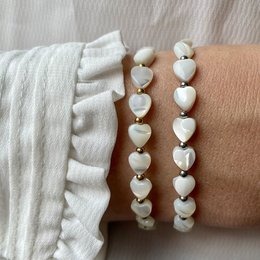 Bracelet with mother of pearl hearts, silver or gold metal, charm bracelet style.