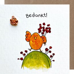 A colorful hand-drawn illustration of a thank you card featuring a whimsical orange bird with red accents, perched on a green hill with red flowers. The text "Bedankt!" is written at the top, which means "Thank you!" in Dutch.