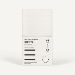 A ruled, zero-waste notebook in a salt color. The notebook features a simple, minimalist design with lined pages.