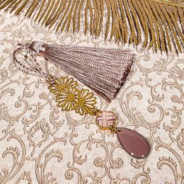 Colorful, decorative bookmarks with tassels, sequins, and floral elements. The bookmarks feature a variety of colors including red, yellow, and purple, and incorporate natural materials like flowers and beads.