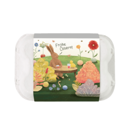  Egg-shaped box containing 6 flower-shaped marbles in vibrant colors, perfect for Easter decorations or gifts. The box features a whimsical, nature-inspired design with flowers, trees, and a happy Easter message.