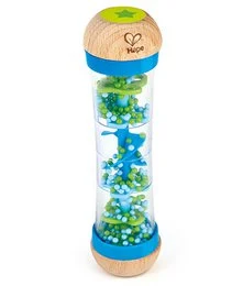 A blue and green baby rattle with beads and a heart-shaped design. The rattle features a cylindrical shape with a wooden handle and a clear plastic chamber filled with colorful beads that move around when shaken.