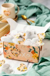 Box of 15 heart-shaped tea sachets in floral print box, containing jasmine, hazelnut, English breakfast, and rooibos pear almond tea varieties.