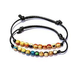 Minimal bracelet with colorful beads in various shades of green, red, blue, and random colors. The bracelet features a simple, adjustable design with a braided cord.