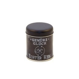 A small black tin container with the label "Gewürz Glück" (Spice Luck) on it, suggesting it contains a seasoning or spice blend.