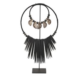  Black metal necklace with circular frame and hanging black feathers, featuring decorative metal charms.