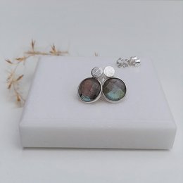 Labradorite stud earrings with round, silver-toned settings. The earrings feature a natural, iridescent blue-green labradorite stone in each setting.