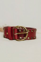  Wide burgundy leather belt with gold studs and brass buckle, studded design