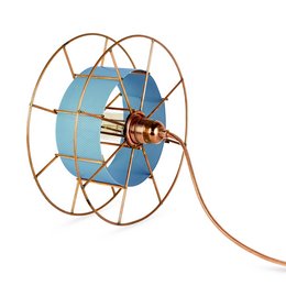 A round, tall floor lamp with a blue glass shade and a copper-colored metal frame. The lamp has a vintage, industrial style with an exposed bulb.