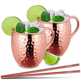 A set of 2 copper-colored Moscow Mule mugs, each with a capacity of 470ml. The mugs feature a hammered texture and come with 2 copper-colored straws and a copper-colored stirrer. This set is perfect for enjoying cocktails in style.