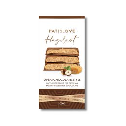  Hazelnut praline and kadayif milk chocolate bar, 100g. Rectangular-shaped chocolate bar with a brown wrapper and visible chocolate and nut pieces inside.