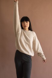 Beige batwing sleeve merino wool sweater with a relaxed, oversized fit.