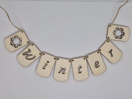  "Wooden winter banner garland with pointed bottom, letters spelling 'gentle', natural wood color, decorative bunting"