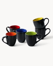 A set of 4 black ceramic coffee cups with blue interiors, featuring a butterfly design on the packaging. The cups have a simple, modern shape and are suitable for everyday use.
