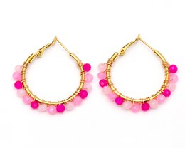  Stainless steel gold-colored statement earrings with an oval design. The earrings feature a textured, hammered finish for a unique, eye-catching look.