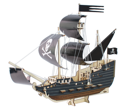 A wooden toy pirate ship with black and white sails, a skull and crossbones flag, and a cannon. The ship has a classic pirate ship design with a tall mast and detailed features.