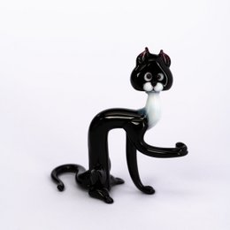 Glass cat figurine with black color and cat-like features.