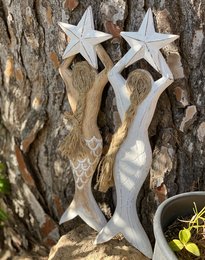 Wooden mermaid wall decor, available in white or brown, featuring a whimsical design with star shapes.