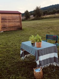 A large, rectangular tablecloth in a farmhouse style, available in various colors including black, green, navy, grey, beige, burgundy, teal, orange, blue, and mustard. The tablecloth features a textured, woven design and measures 100 x 180 cm (39 x 70 inches).