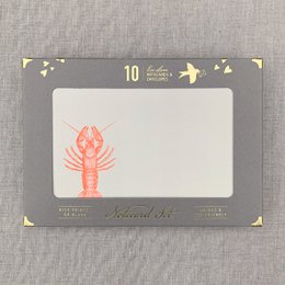  Notecard set with riso printed lobster design on a sustainable card. The notecard features a vibrant red lobster illustration against a neutral gray background with minimal decorative elements.