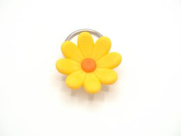 Yellow daisy flower keychain with orange center, round floral shape, cheerful bright design.