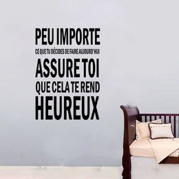 Decorative wall stickers with French text "Peu importe que cela te rend heureux" (It doesn't matter what makes you happy).