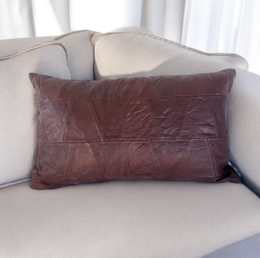 Genuine leather cushion in a deep burgundy color, with a rectangular shape and a textured leather surface.