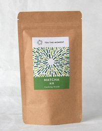  "Culinary grade matcha powder in kraft paper pouch with green label and sunburst design"