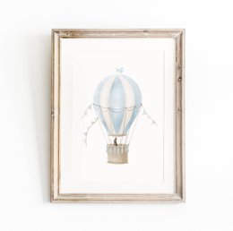  Whimsical hot air balloon print in a wooden frame, perfect for a boys nursery or kids room. Features a blue hot air balloon with a bunny passenger.