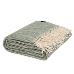  A light green and cream colored plaid throw blanket with a herringbone pattern. The throw is made of wool and has long fringes along the edges.