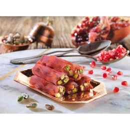 Pomegranate-flavored gummy candy with pistachios and pomegranate seeds. Sweet and tart flavors, chewy texture, hexagonal shape.