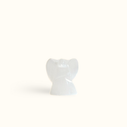  Selenite angel statue, a decorative figurine made of translucent white selenite mineral with an angelic shape.